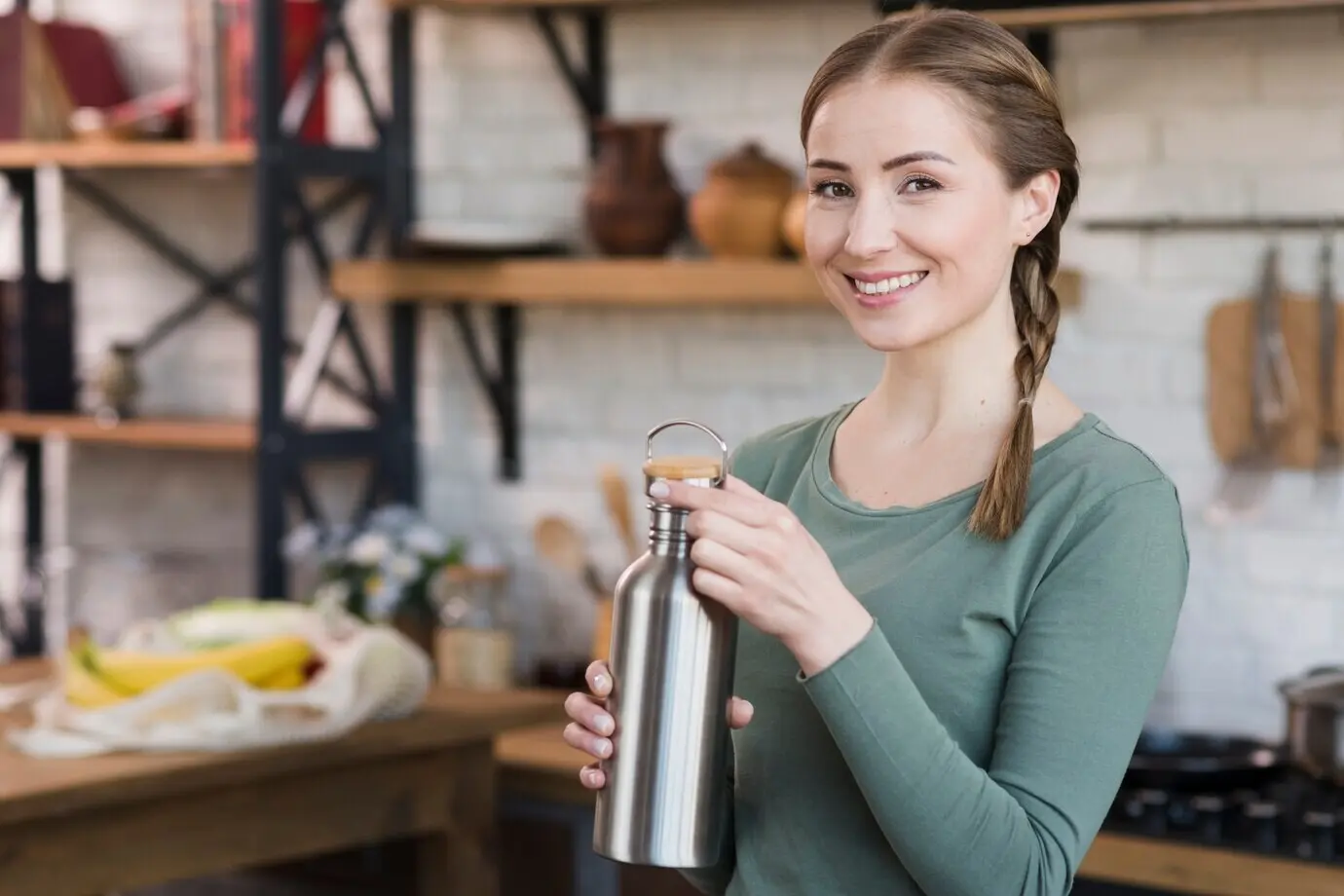 A portrait of a beautiful young woman holding a thermos